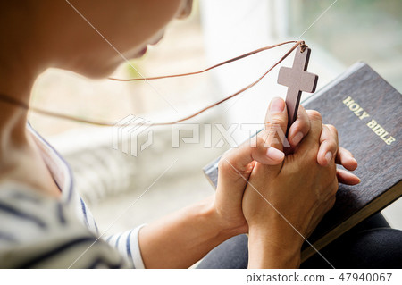 Christian woman praying on holy bible. Christian woman praying on holy bible. 47940067
