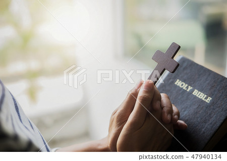 Christian woman praying on holy bible. Christian woman praying on holy bible. 47940134
