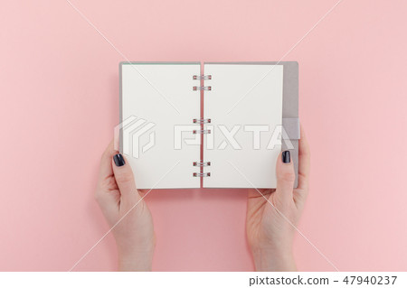 Woman hands with blank notepad mockup Woman hands with blank notepad mockup 47940237