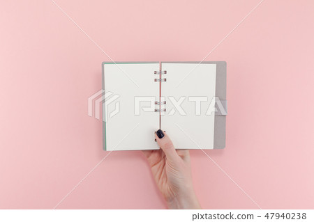 Woman hands with blank notepad mockup Woman hands with blank notepad mockup 47940238