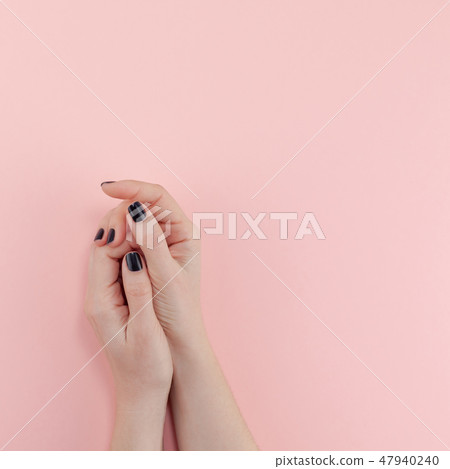 Woman's hands with black manicure Woman's hands with black manicure 47940240