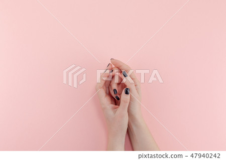 Woman's hands with black manicure Woman's hands with black manicure 47940242