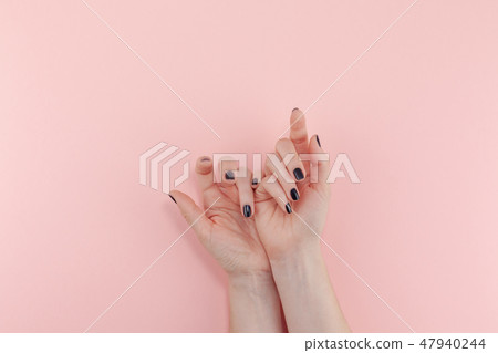 Woman's hands with black manicure Woman's hands with black manicure 47940244