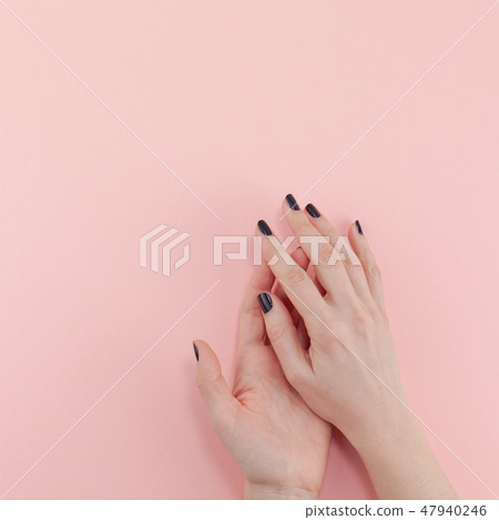 Woman's hands with black manicure Woman's hands with black manicure 47940246