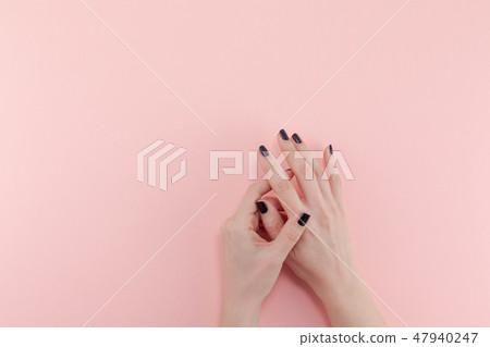 Woman's hands with black manicure Woman's hands with black manicure 47940247