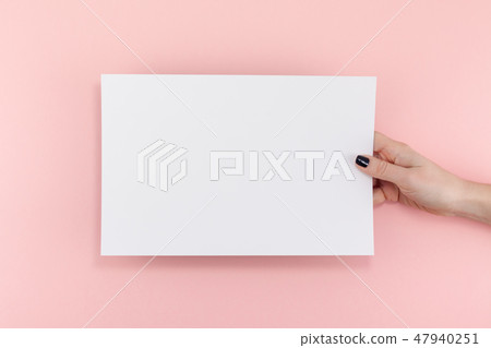 Woman hands with blank A4 paper sheet mockup Woman hands with blank A4 paper sheet mockup 47940251