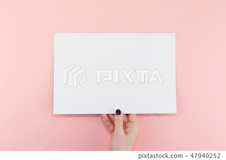 Woman hands with blank A4 paper sheet mockup Woman hands with blank A4 paper sheet mockup 47940252