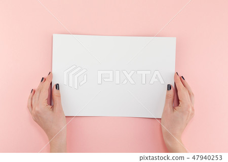Woman hands with blank A4 paper sheet mockup Woman hands with blank A4 paper sheet mockup 47940253