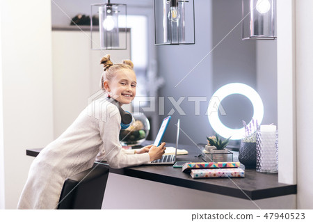 Cute blue-eyed long-haired girl with a nice hairstyle feeling positive Cute blue-eyed long-haired girl with a nice hairstyle feeling positive 47940523
