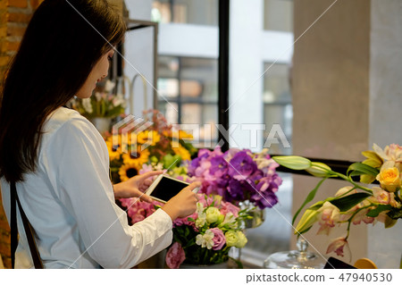 Cheerful charming young business owner flower shop 47940530
