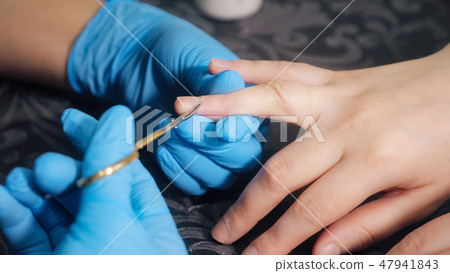 Closeup shot of a woman hands in nail salon receiving a manicure by a beautician 47941843