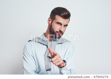 I choose you! Charming bearded man in casual wear gesturing and looking at you against grey I choose you! Charming bearded man in casual wear gesturing and looking at you against grey 47944274