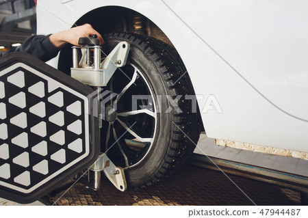 A Car on the Car Steering Wheel Balancer and Calibrate with laser reflector attach on each tire to 47944487