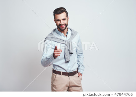 I choose you! Happy and smiling handsome man pointing his finger and looking positive at camera 47944766