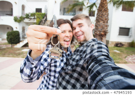 Property, real estate and apartment concept - Happy funny young couple showing a keys of their new Property, real estate and apartment concept - Happy funny young couple showing a keys of their new 47945193