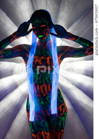 Naked woman in glowing neon signs on body  47945607