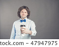 Portrait of happy handsome man in blue shirt and bow tie with paper cup of morning coffee. Good 47947975