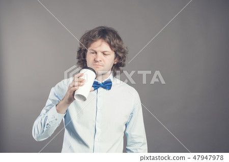 Close up portrait of happy handsome man in blue shirt with paper cup of morning coffee. Good morning 47947978