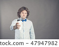 Close up portrait of happy handsome man in blue shirt with paper cup of morning coffee. Good morning 47947982