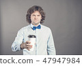 Close up portrait of happy handsome man in blue shirt with paper cup of morning coffee. Good morning 47947984