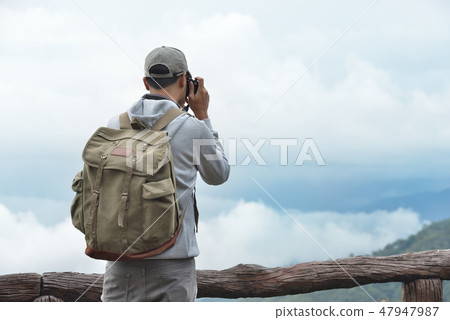 Young man travel photographer taking nature photo Young man travel photographer taking nature photo 47947987