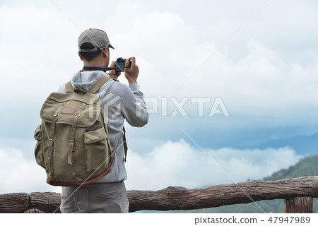 Young man travel photographer taking nature photo Young man travel photographer taking nature photo 47947989