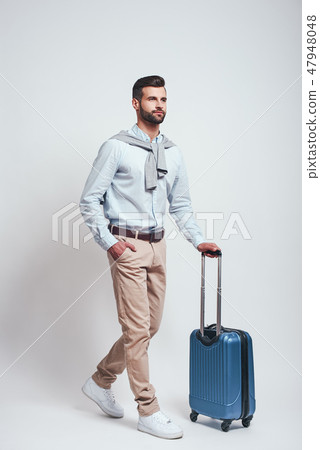 Travel concept. Full length of charming bearded man with a luggage. 47948048