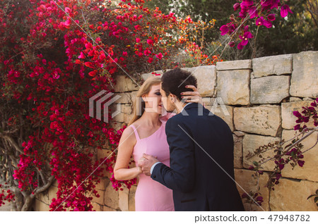 Man and woman together walking and kissing Man and woman together walking and kissing 47948782