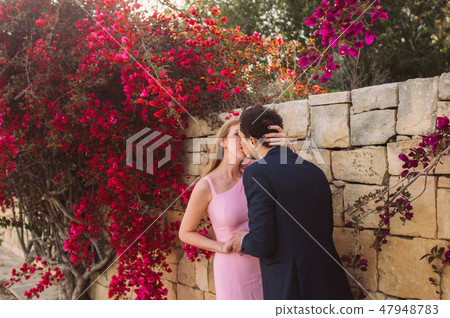 Man and woman together walking and kissing Man and woman together walking and kissing 47948783