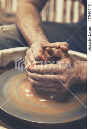 Pottery. The master at the potter's wheel, produces a vessel of clay 47949848