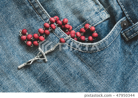 Catholic rosary in the jeans pocket 47950344
