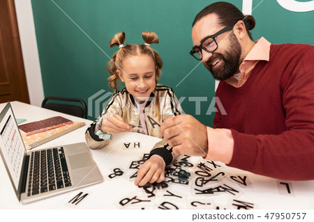 Pretty fair-haired girl with bracelets on her hand feeling involved 47950757