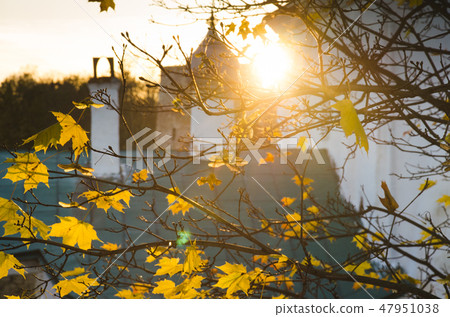 Autumn foliage and some chutch on background. sunny day. Autumn foliage and some chutch on background. sunny day. 47951038