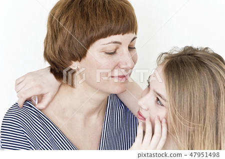 Beautiful mother and daughter on white Beautiful mother and daughter on white 47951498