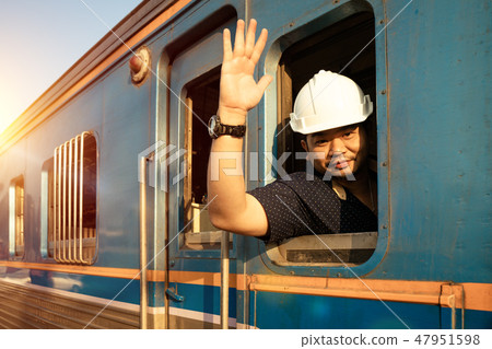 Train driver checking engine of train 47951598