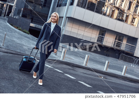On the way to business meeting. Full length of young woman in suit On the way to business meeting. Full length of young woman in suit 47951706