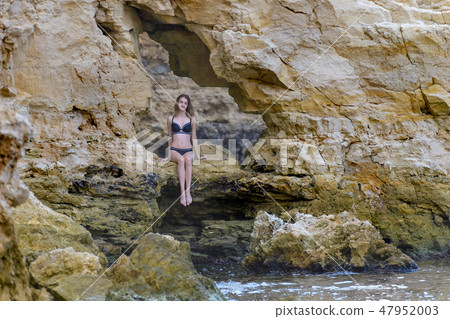 Young girl in black bikini 47952003
