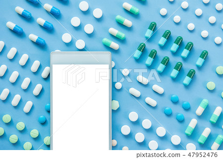 Empty cellphone screen on medical pills background 47952476