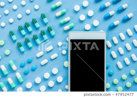 Empty cellphone screen on medical pills background 47952477