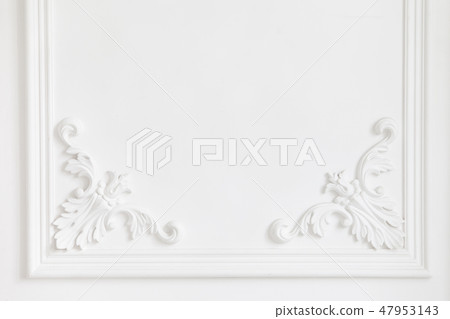 Beautiful ornate white decorative plaster mouldings in studio. The white wall is decorated with Beautiful ornate white decorative plaster mouldings in studio. The white wall is decorated with 47953143