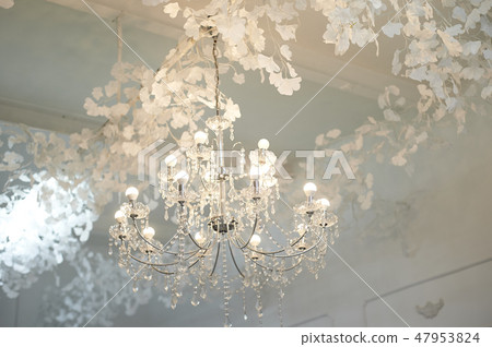 Several crystal chandeliers under the ceiling.Luxury and brilliance Several crystal chandeliers under the ceiling.Luxury and brilliance 47953824