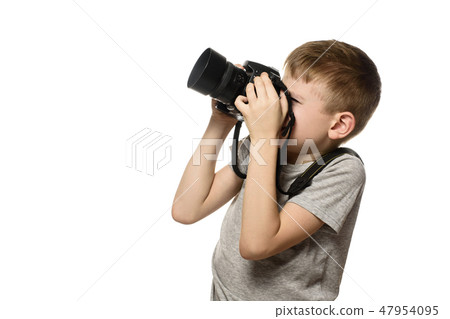 Boy takes pictures on camera. Portrait. Isolate Boy takes pictures on camera. Portrait. Isolate 47954095