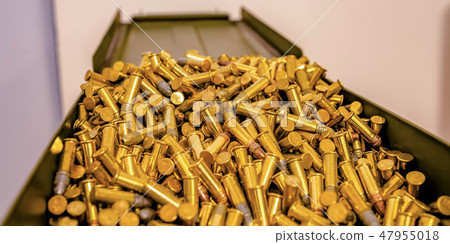Reflective golden bullets on an open metal box Reflective golden bullets on an open metal box 47955018