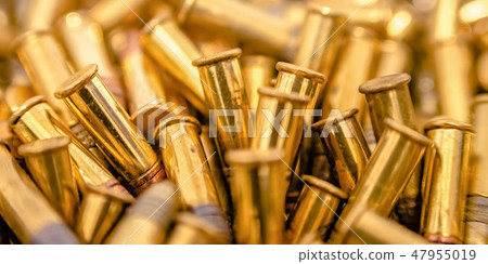 Reflective golden bullets clustered together Reflective golden bullets clustered together 47955019