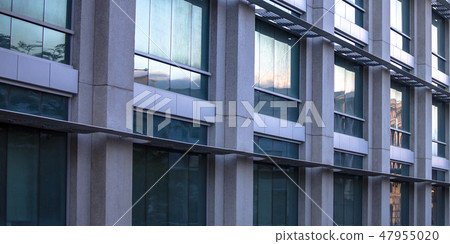 Reflective glass windows on a modern building 47955020