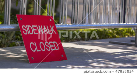 Red sidewalk closed sign on a sunny pavement Red sidewalk closed sign on a sunny pavement 47955034