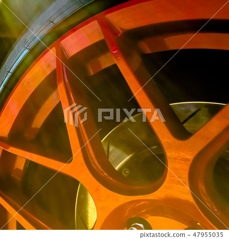 Red rims with sunlight bouncing of its surface 47955035