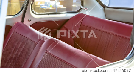 Red leather seats of an old fashioned compact car Red leather seats of an old fashioned compact car 47955037