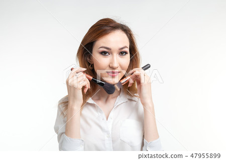 Beauty makeup artist. Close Up korean beautiful young woman pretty smiling holding make-up brushes Beauty makeup artist. Close Up korean beautiful young woman pretty smiling holding make-up brushes 47955899