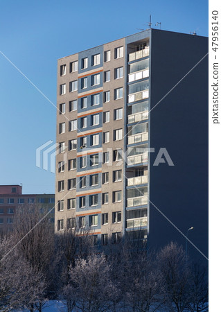 Insulated panel house apartments behind trees 47956140